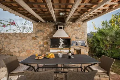 a table with a plate of fruit on a patio at Seafront Villa Shore, Sea & Sun Villas in Chorafakia