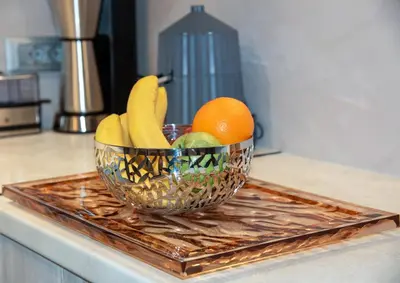 a bowl of fruit on a tray on a counter at Flos Apartments in Korakiaí