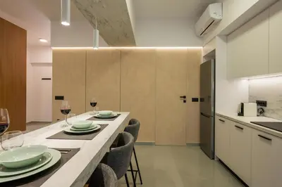 a kitchen with a long table with plates and wine glasses at Amara Local Experience in Chania Town