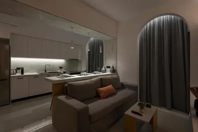 a living room with a couch and a kitchen at Amara Local Experience in Chania Town