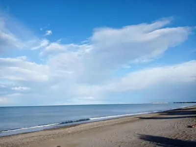 a beach with a blue sky and the ocean at Micro_Ble vacation home in Ropanianá