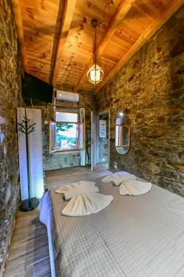 a room with four pillows in a stone wall at Traditional Stone House with Mountain & Sea Views 
