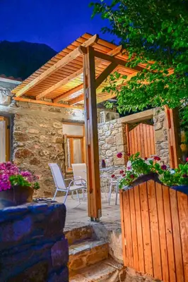 a wooden pergola on a patio of a house at Traditional Stone House with Mountain & Sea Views 