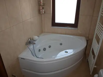 a white bath tub in a bathroom with a window at Villa Helidoni in Pondikianá