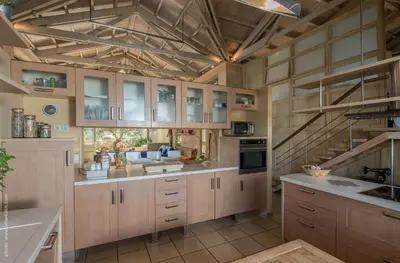 a large kitchen with wooden cabinets and a ceiling at Villa Dimi in Kalathas
