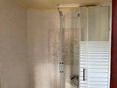 a shower with a glass door in a bathroom at IFIGENIA ROOMS BY MARIOS in Chania Town
