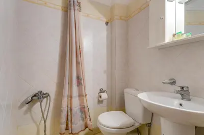 a bathroom with a toilet and a sink at IFIGENIA ROOMS BY MARIOS in Chania Town