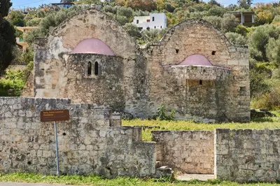 an old stone building with pink domes on a hill at La Maison to Chani in Stílos