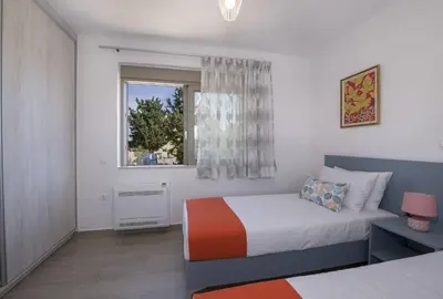 a bedroom with a bed and a window at Almyrida Hills Villas in Koprána