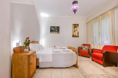 a bedroom with a bed and a living room at Seafalios Villa in Chania Town