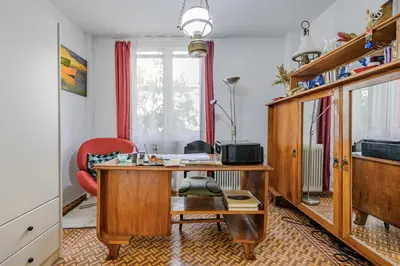 an office with a wooden desk and a red chair at Seafalios Villa in Chania Town