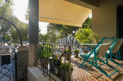 a balcony with a table and chairs and a table at Seafalios Villa in Chania Town