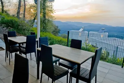 a table and chairs on a patio with a view at Kandania Paradise in Kántanos