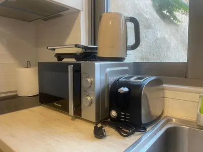 a kitchen with a coffee maker on top of a counter at AIOLOS Chania center luxury apartment near the garden in Chania Town