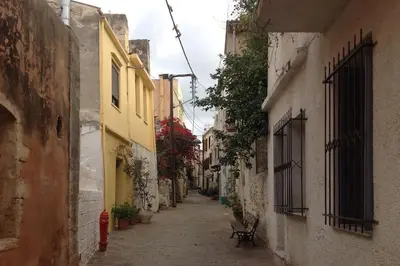 an alley with buildings and a red fire hydrant at Splatzia old town house in Chania Town