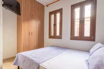 a small bedroom with a bed and a window at Splatzia old town house in Chania Town