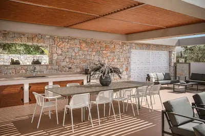 a kitchen and dining room with a table and chairs at Villa Aora Falassarna Beach I New luxury villa with infinity pool in Falasarna