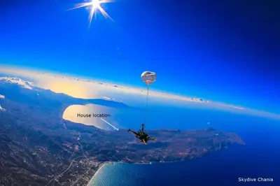 a person riding a hot air balloon in the sky at 2 annexed apartments -Private place to swim-large terrace- Unlimited view in Ravdhoúkha