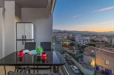 a table on a balcony with a view of a city at Nikolas City Home in Chania Town