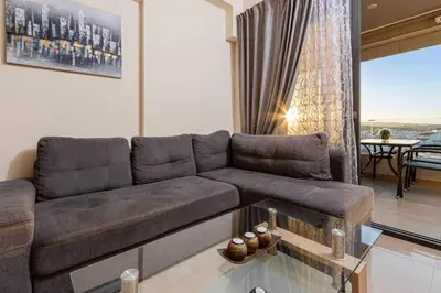 a living room with a couch and a table at Nikolas City Home in Chania Town