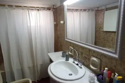 a bathroom with a sink and a shower curtain at Spacious Sunny house in Chania in Chania Town