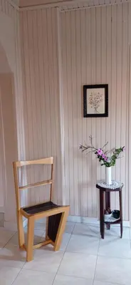 a chair and a table with a vase of flowers at Spacious Sunny house in Chania in Chania Town