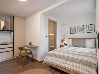 a bedroom with a bed and a small table at Casa 28 City Apartments in Chania Town