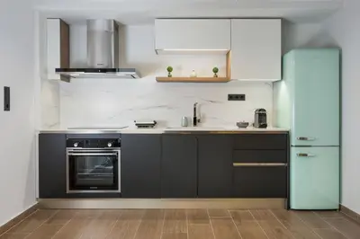 a kitchen with a sink and a refrigerator at Casa 28 City Apartments in Chania Town