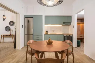 a kitchen and dining room with a table and chairs at Casa 28 City Apartments in Chania Town