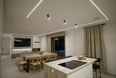 a kitchen and living room with a table and chairs at Villa Mourelo luxury villa in chania with private pool jacuzzi in Chania Town
