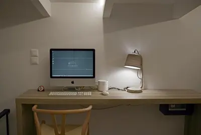a desk with a computer monitor and a lamp at Villa Mourelo luxury villa in chania with private pool jacuzzi in Chania Town