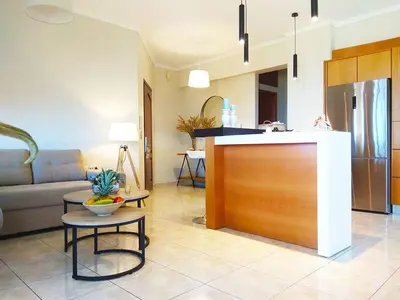 a living room with a couch and a kitchen at Stelia Apartment Gerani in Ayiá