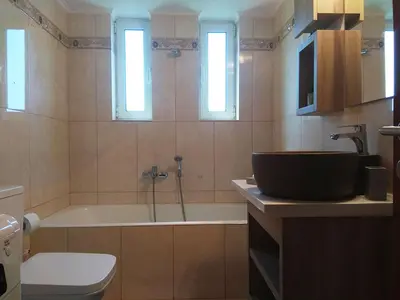a bathroom with a tub and a toilet and a sink at Stelia Apartment Gerani in Ayiá