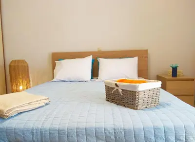 a bedroom with a bed with a basket on it at Stelia Apartment Gerani in Ayiá