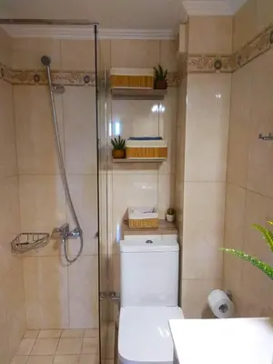 a bathroom with a toilet and a glass shower at Stelia Apartment Gerani in Ayiá
