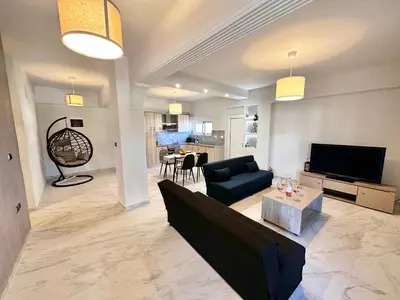 a living room with a couch and a table at Sophia's Smile in Kounoupidhianá