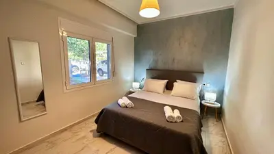 a bedroom with a bed with two shoes on it at Sophia's Smile in Kounoupidhianá