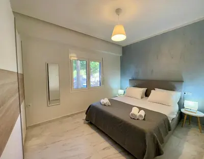 a bedroom with a large bed with two towels on it at Sophia's Smile in Kounoupidhianá