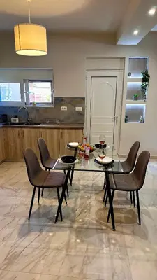 a dining room with a glass table and chairs at Sophia's Smile in Kounoupidhianá