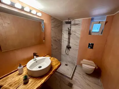 a bathroom with a sink and a shower and a toilet at Sophia's Smile in Kounoupidhianá