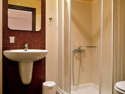a bathroom with a shower and a sink and a toilet at Corali Studios in Palaiochóra