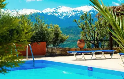 a swimming pool with a view of mountains at Anemole Traditional Cretan Villa in Megála Khoráfia