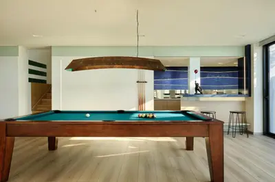 a pool table in the middle of a living room at Villa St John - Wellness & Entertainment by etouri in Chania Town