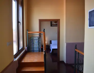 a hallway with stairs and a room with a bed at Venetian Cistern Villa in Kalamítsion Alexándrou