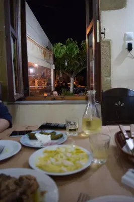 a table with plates of food and a bottle of wine at Venetian Cistern Villa in Kalamítsion Alexándrou