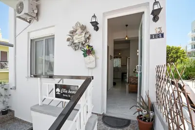 a front door of a house with a sign on it at Elie's House next to the beach in Chania Town