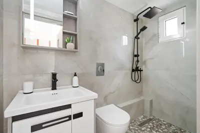 a bathroom with a toilet and a sink and a shower at Elie's House next to the beach in Chania Town