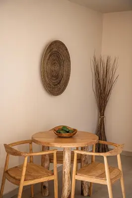 a wooden table with two chairs and a plate on it at Nomada Chania Apartments in Chania Town