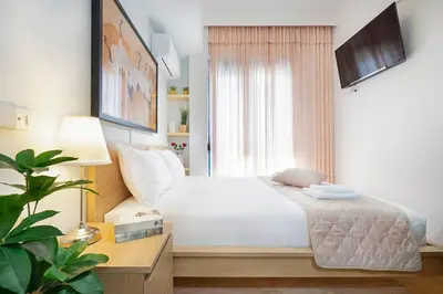 a bedroom with a white bed and a window at Home Philip III in Chania Town