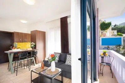 a living room and kitchen with a couch and a table at Home Philip III in Chania Town
